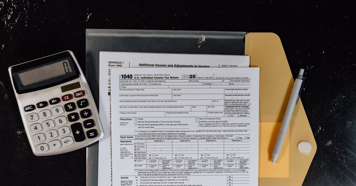 A U.S. individual income tax return form beside a calculator